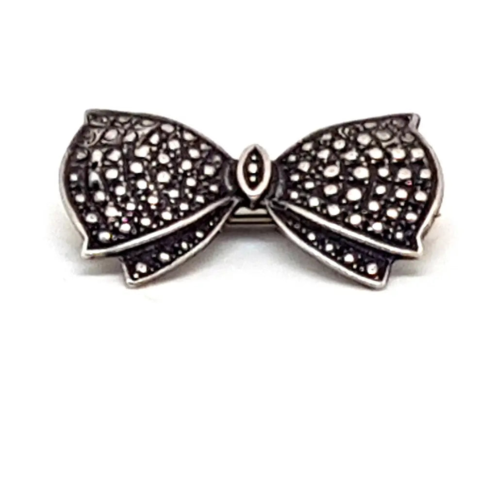 Broche de plata vintage con forma lazo en grabada. Circa 1960. Joyería