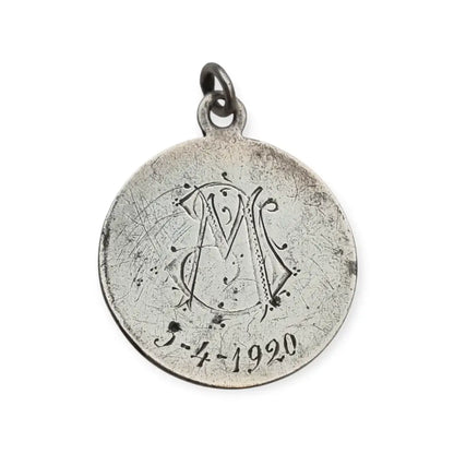 Medalla religiosa antigua en plata maciza de San José y el Niño fechada 1920.