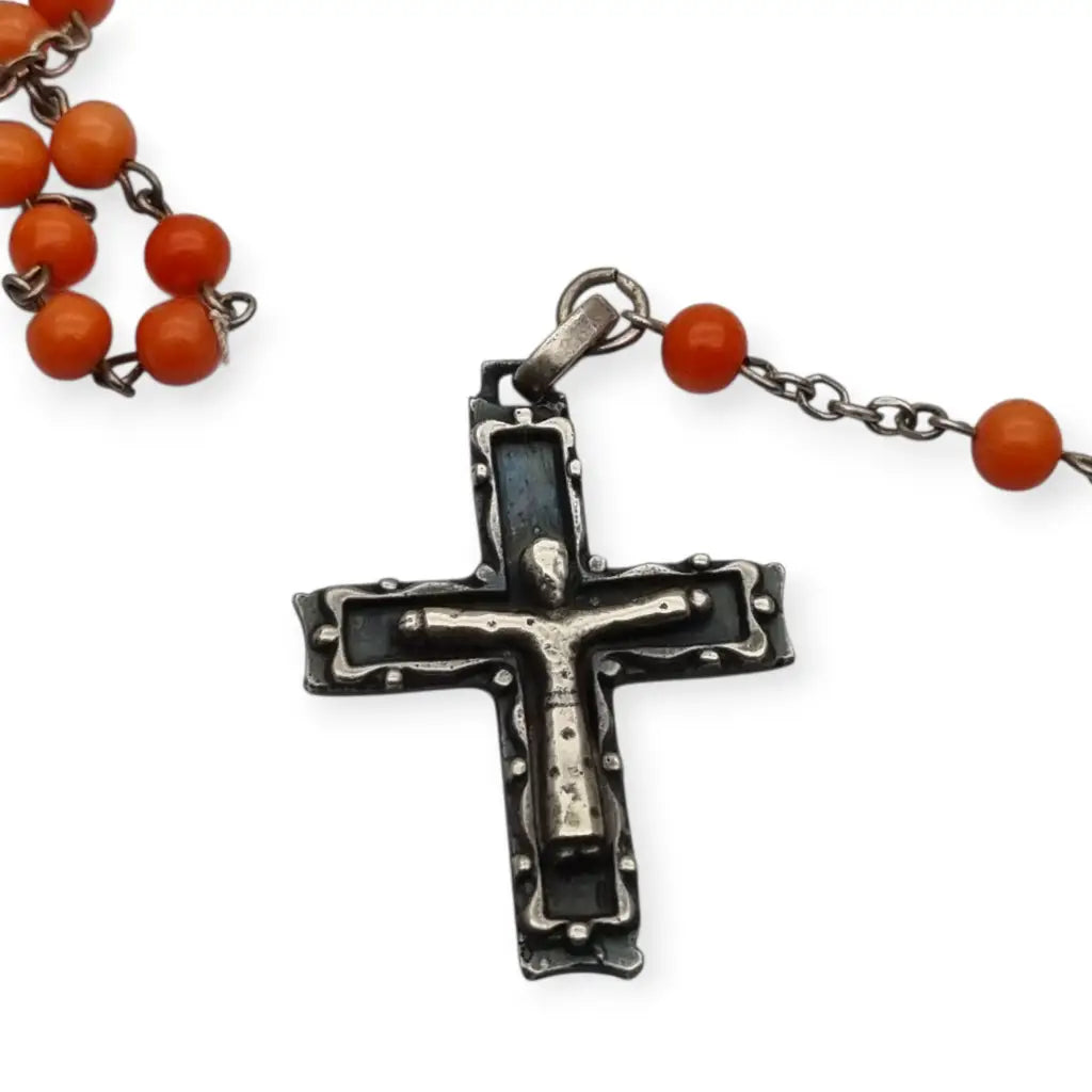 Rosario en plata con cuentas de coral rojo cruz estilizada artesanal estilo